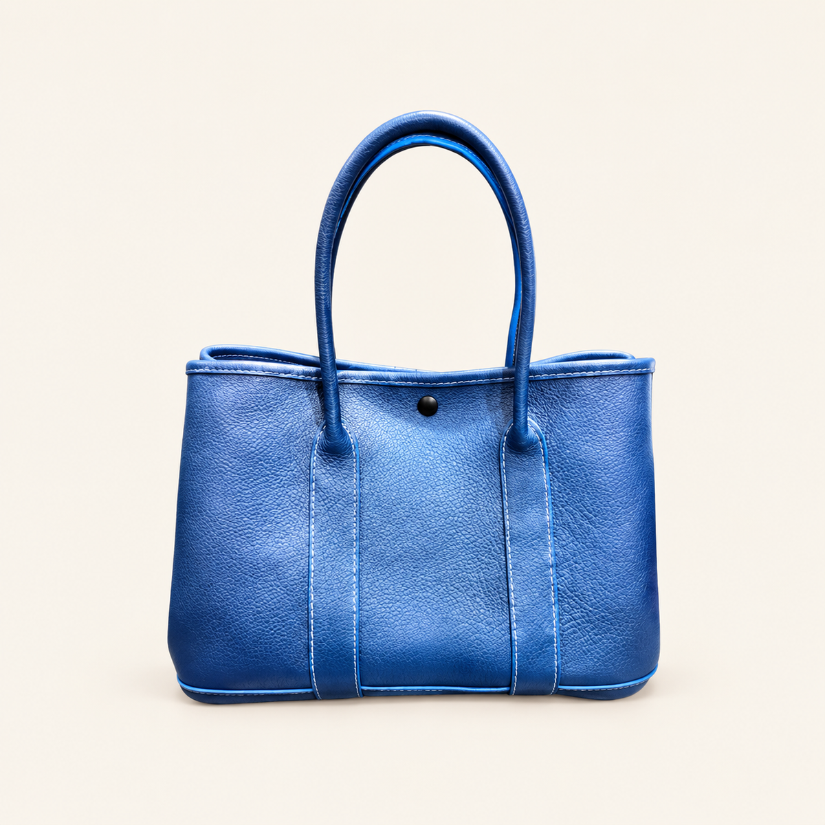 Pebbled Leather Tote on a warm ivory studio background